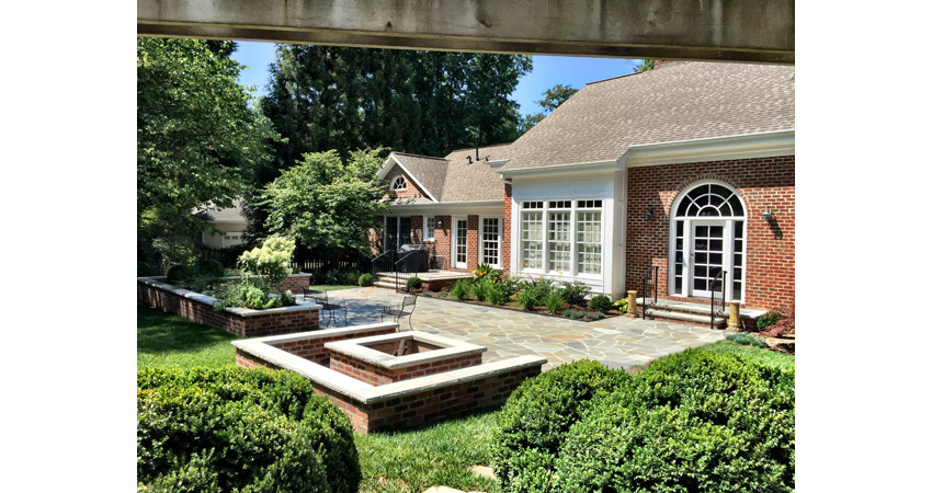 House with patio and fire pit after Benton Outdoor Living