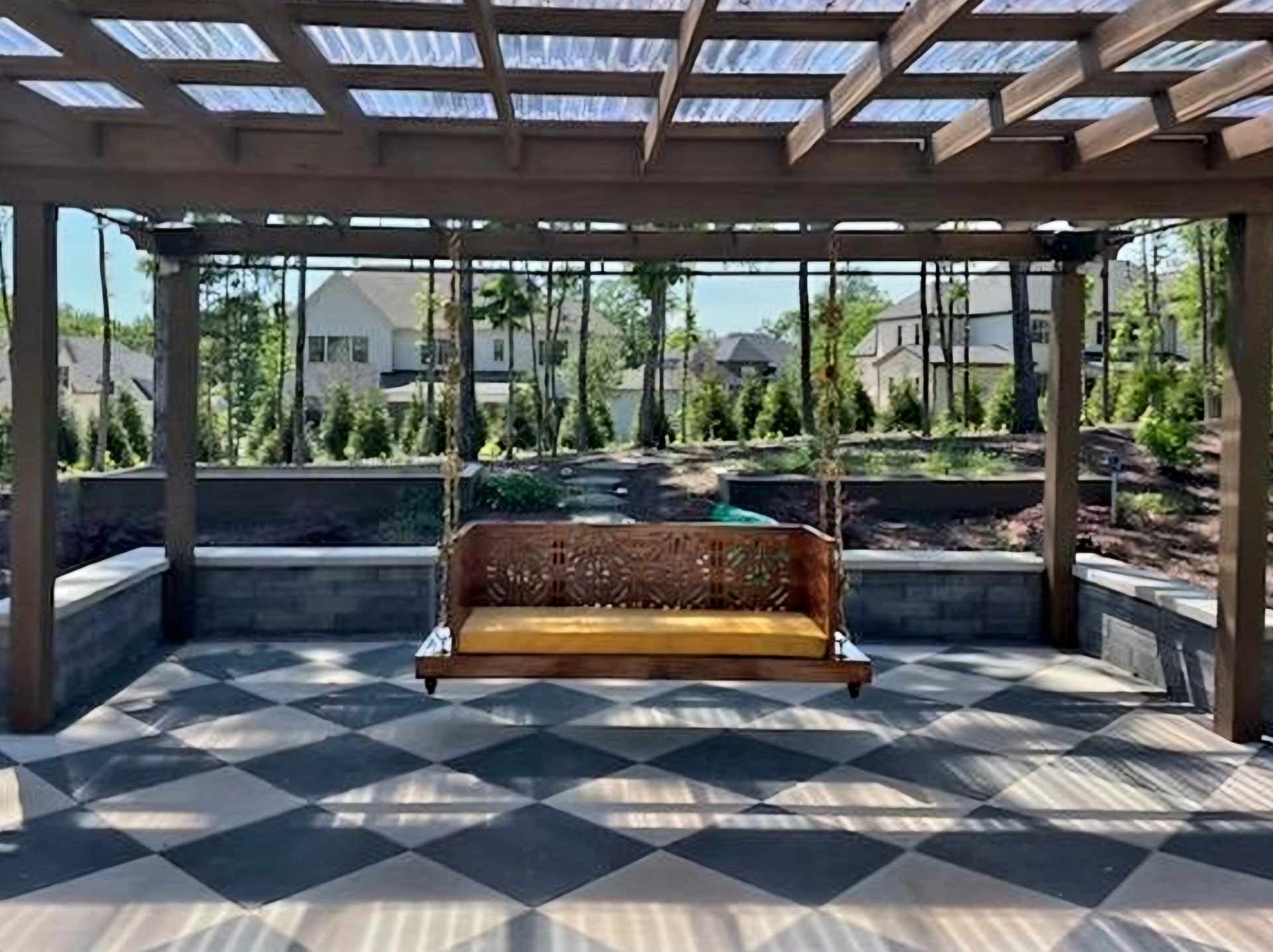 Pergola with roof and swing on a patio in Charlotte by Bentong Outdoor Living